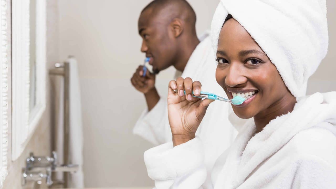 Couple brushing their teeth