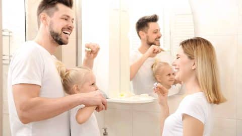 Family brushing their teeth